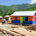 **

A diverse group of volunteers working together on a Habitat for Humanity construction project in Haiti. Focus on the collaborative spirit, using bright colors and showing the construction of simple, sturdy housing. In the background, include lush green hills typical of the Haitian landscape.

**